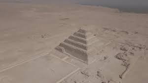 Aerial view of the Step Pyramid of Saqqara rising from the flat desert landscape