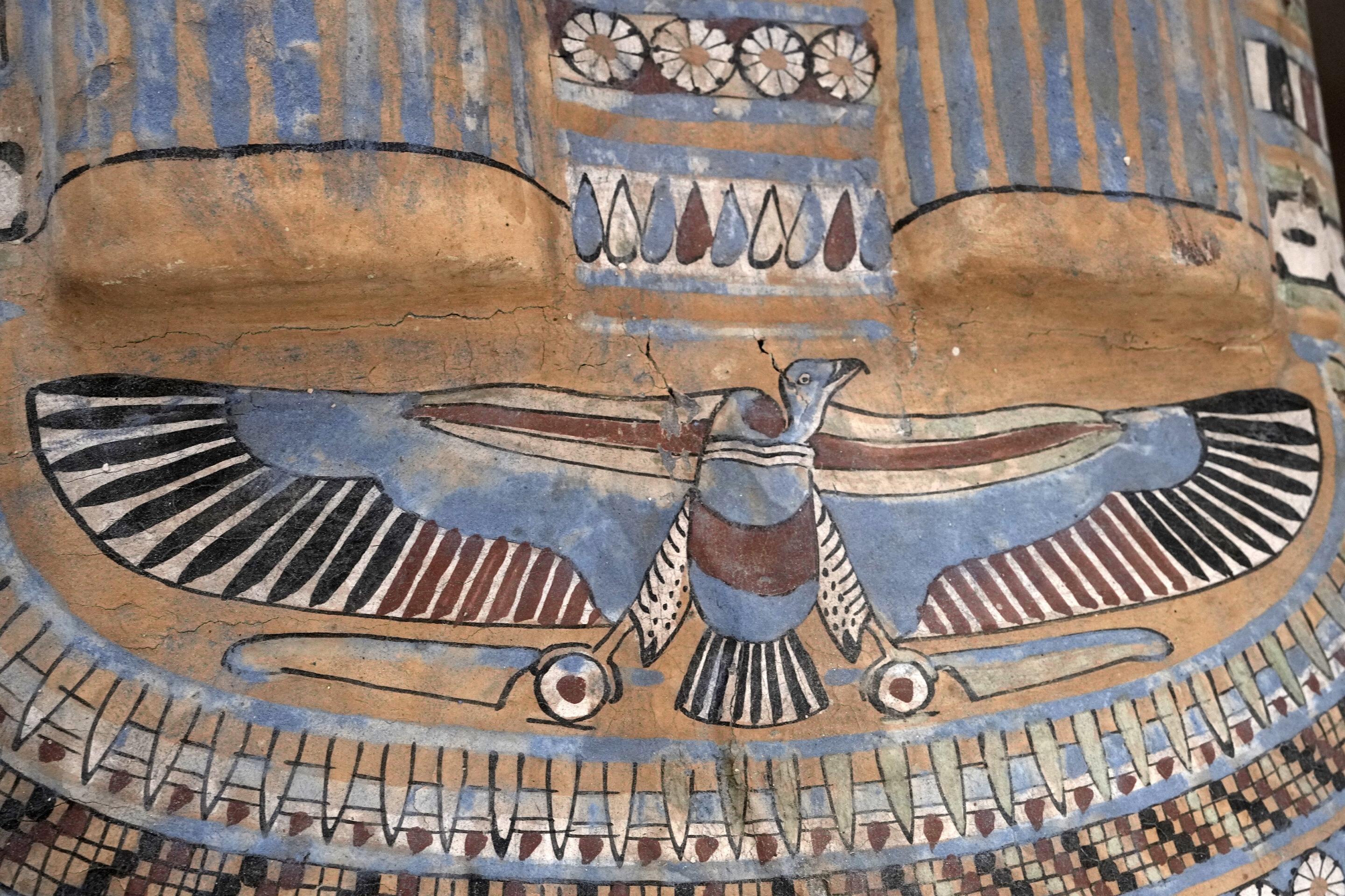Colorful painted winged scarab beetle on an ancient Egyptian sarcophagus at Saqqara
