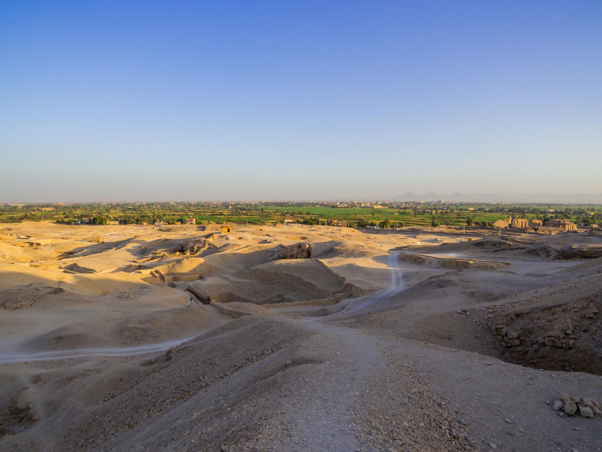 View from the Theban necropolis across the desert toward Luxor's green fields.