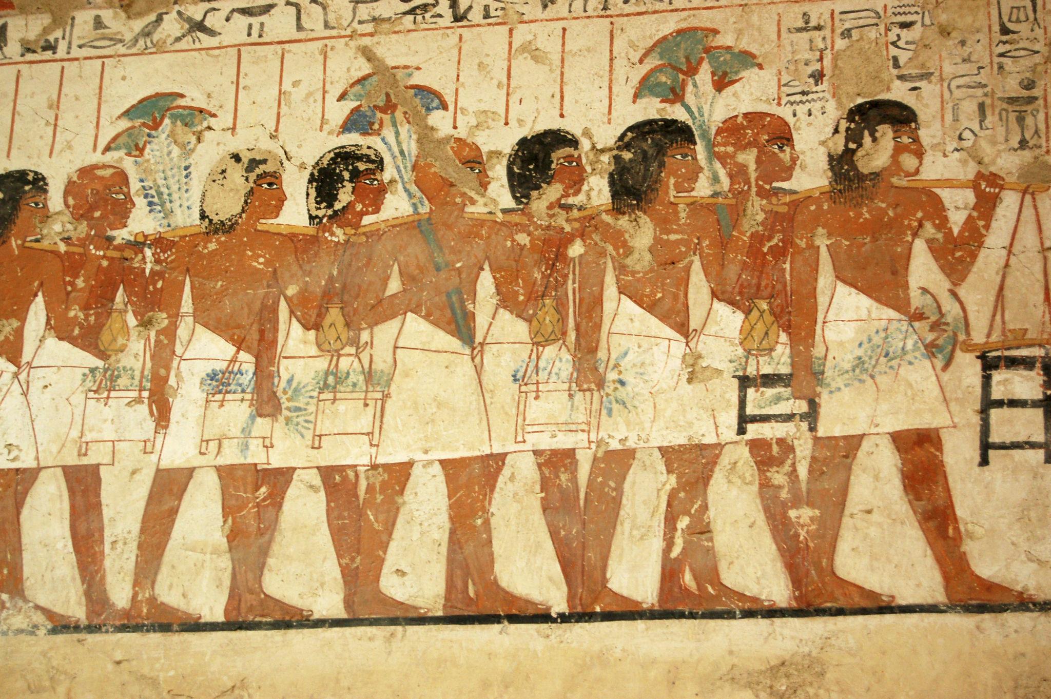 Painted procession of offering bearers carrying goods for the tomb owner.