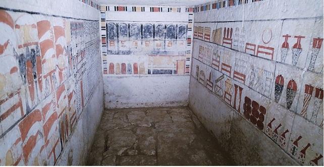 Tomb chamber walls painted with rows of offerings and funerary goods.