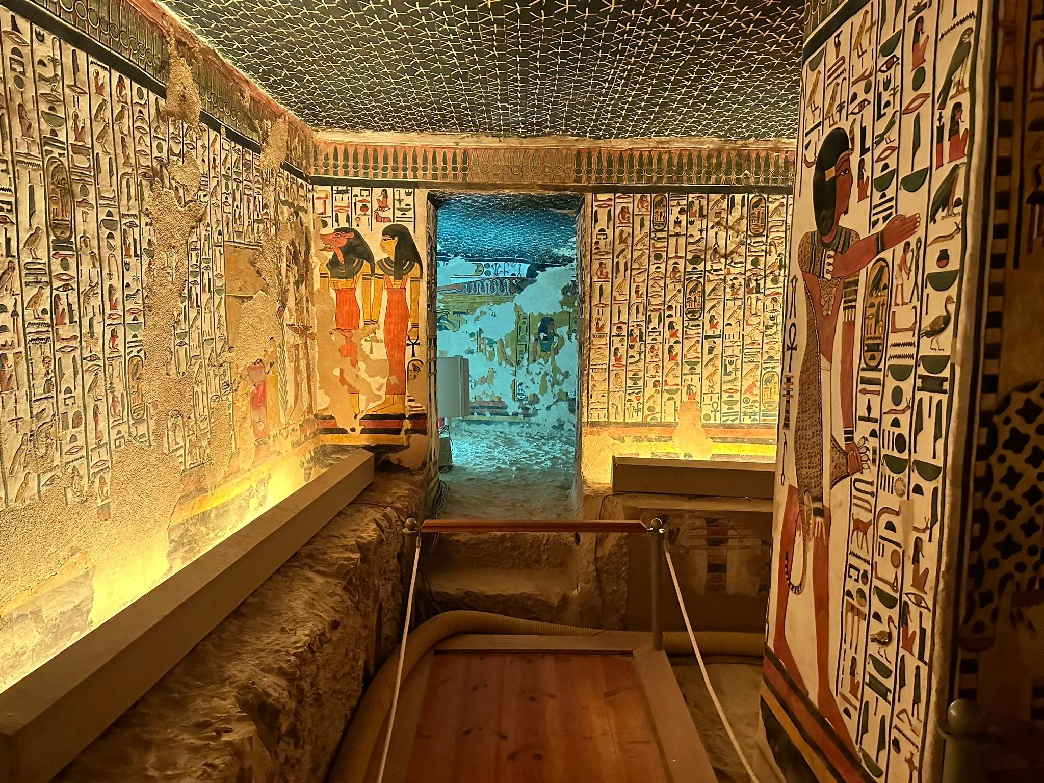 Restored burial chamber with starred ceiling, sarcophagus and painted walls.
