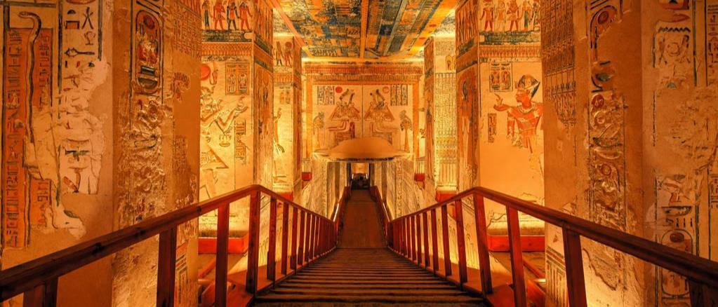 Wide wooden staircase descending into a lavishly painted royal tomb of Ramesses.