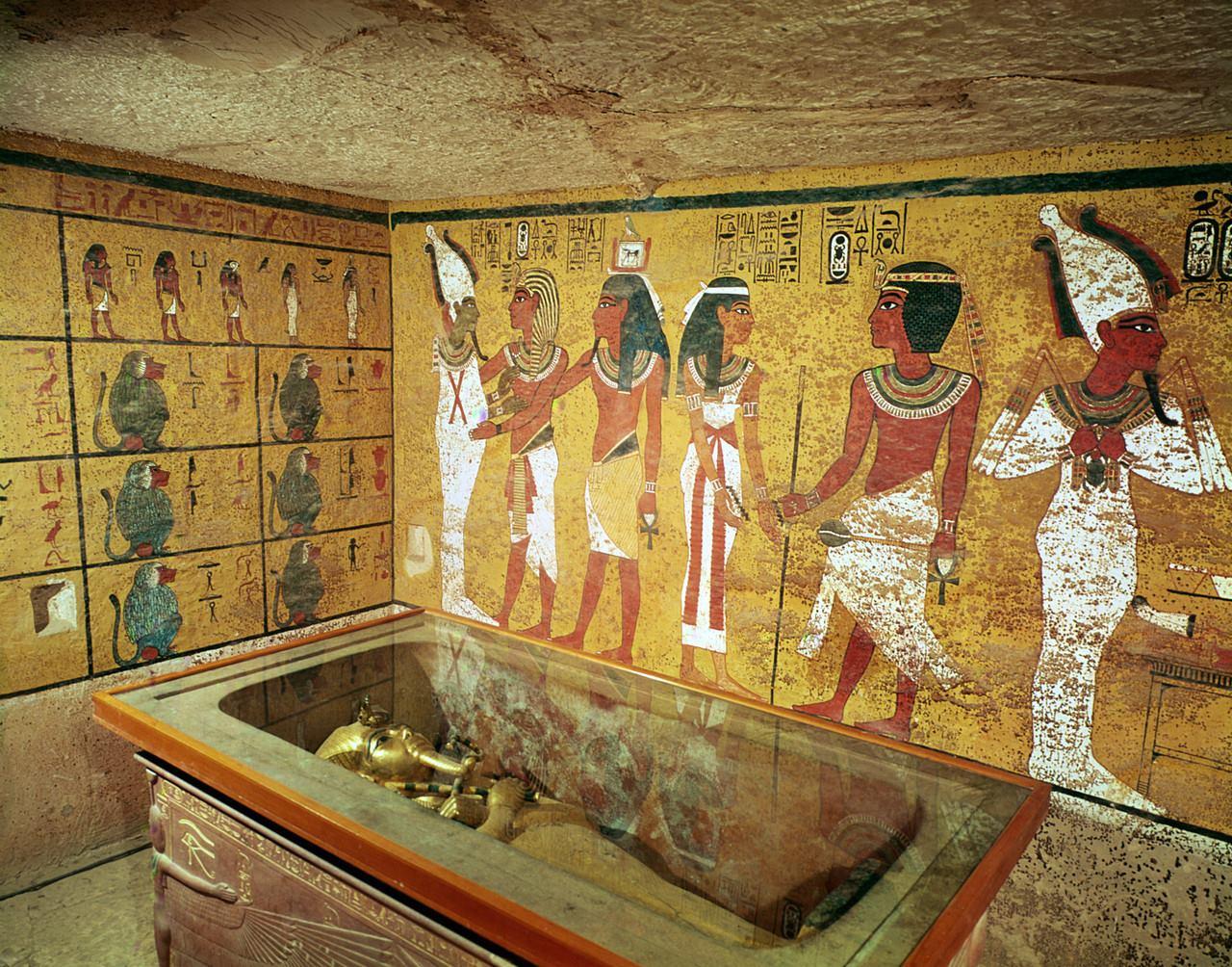 Burial chamber of Tutankhamun with painted baboons and procession of gods above the sarcophagus.