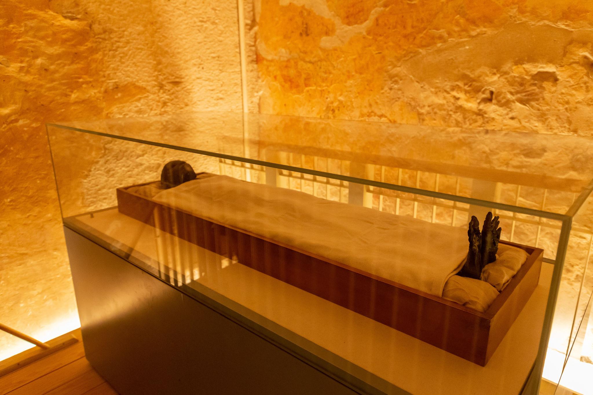 Mummy of Tutankhamun inside a climate-controlled glass case in his tomb at the Valley of the Kings.