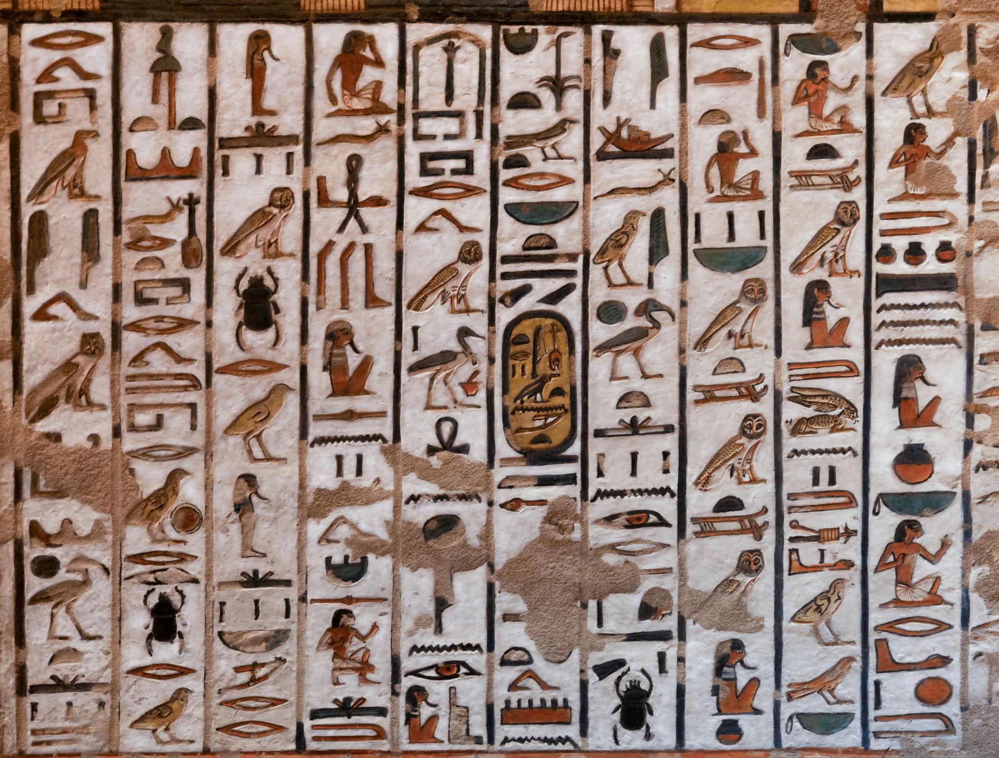 Columns of brightly painted hieroglyphic spells covering a tomb wall.