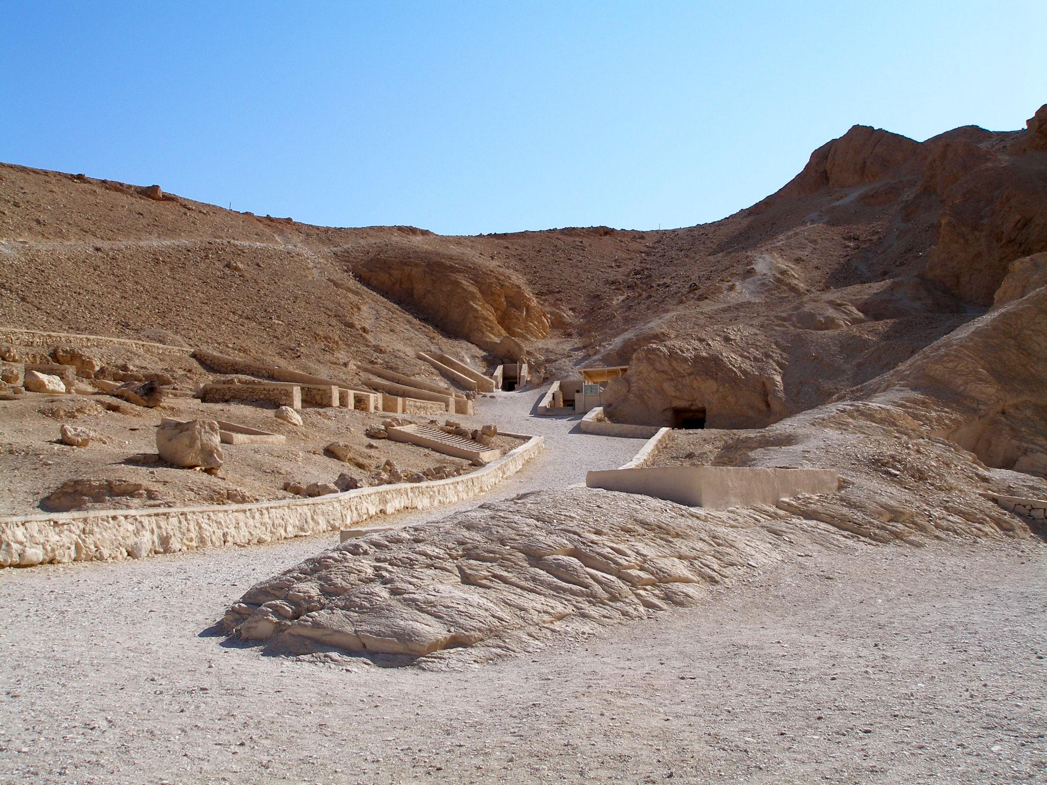 Cluster of tomb entrances set into the limestone hills of the Valley of the Queens.